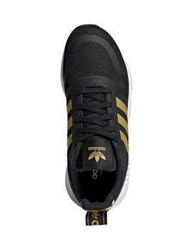 Zapatillas adidas negro dorado de niño.